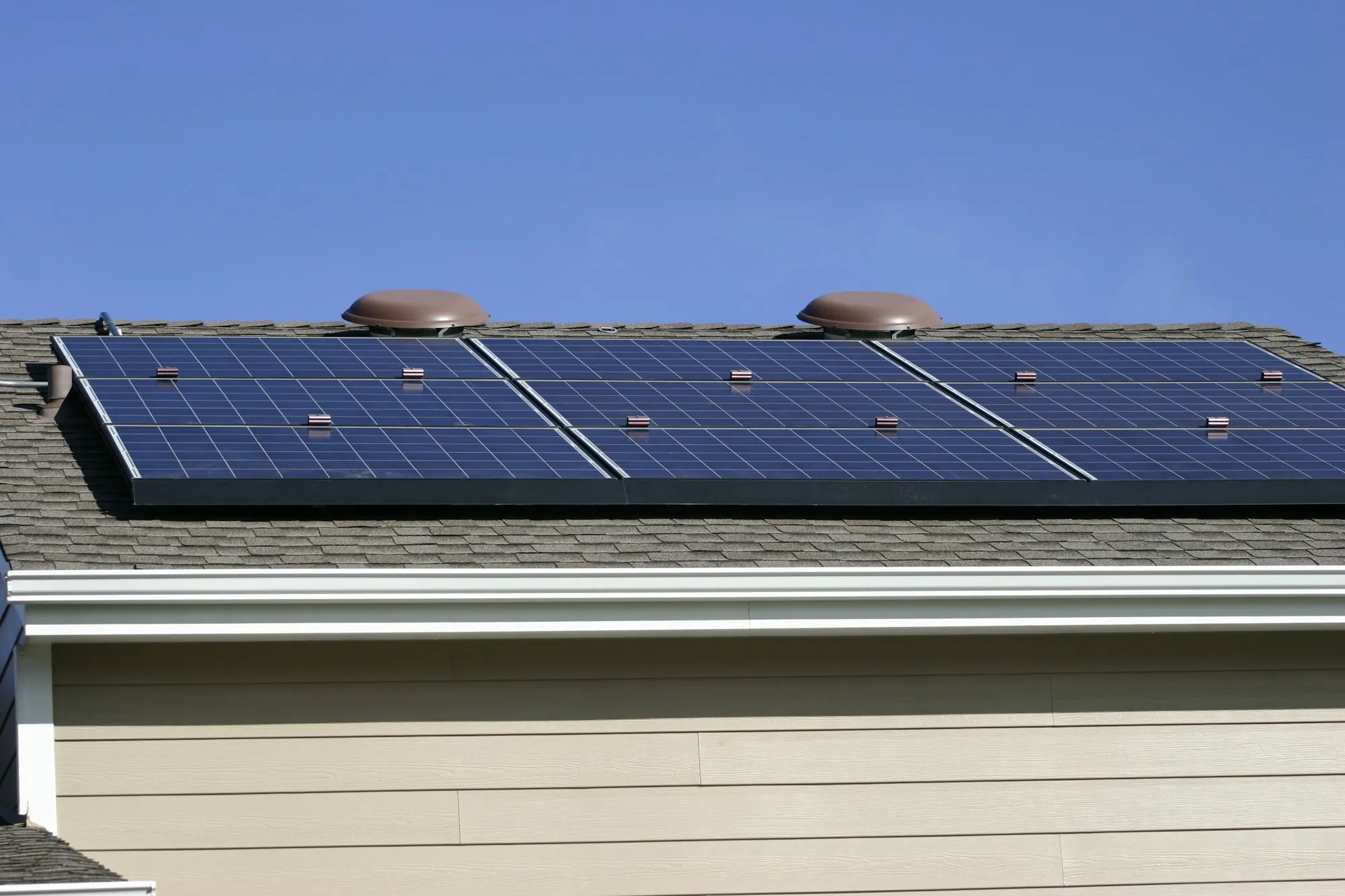 Diagonal rows of blue solar panels seen from above, the kind of array that needs protecting during removal for a Palos Hills reroof